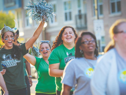 Seven students cheering on Euclid Ave