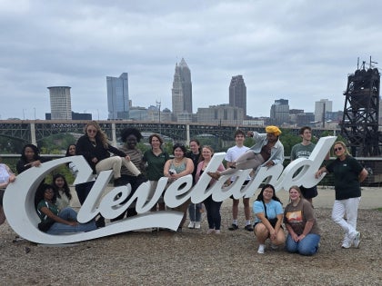 Students posting at sign Cleveland